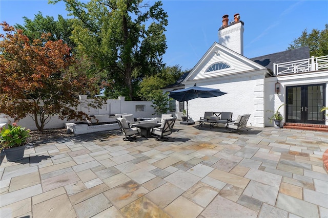 view of patio featuring an outdoor living space and french doors