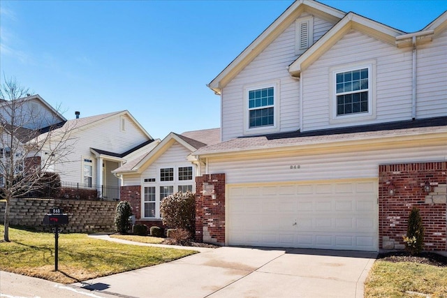 traditional-style home with brick siding, driveway, and a front yard