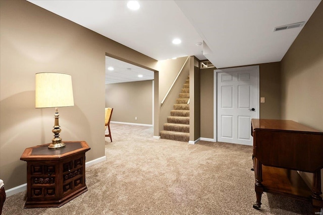 finished below grade area featuring visible vents, baseboards, carpet, stairs, and recessed lighting