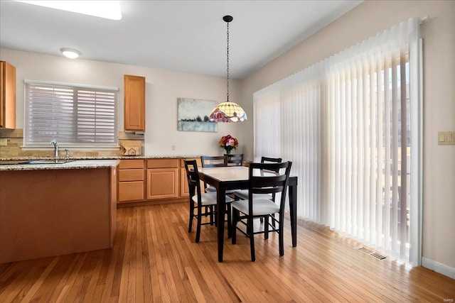 dining room featuring visible vents and light wood finished floors