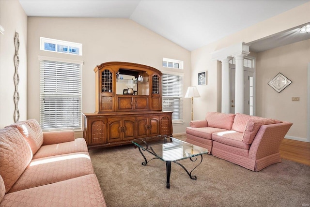 living room featuring vaulted ceiling, baseboards, and ornate columns