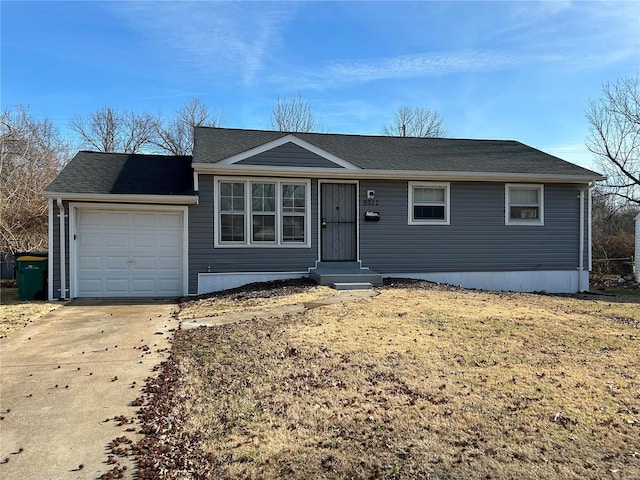 view of front of house featuring a garage and a front lawn