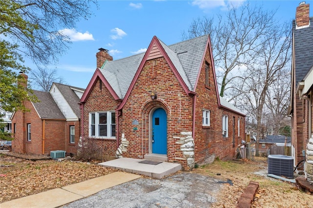 tudor home featuring central air condition unit