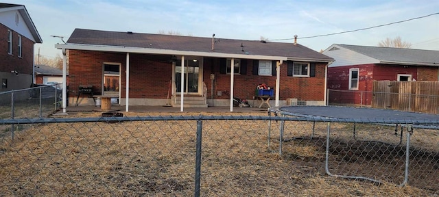 back of house featuring a trampoline