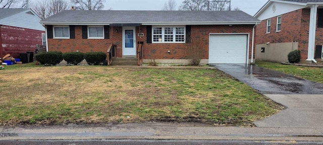 ranch-style house featuring a garage and a front lawn