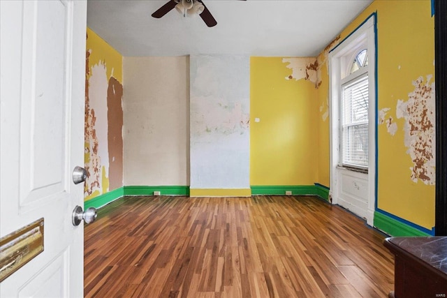 empty room featuring hardwood / wood-style floors and ceiling fan