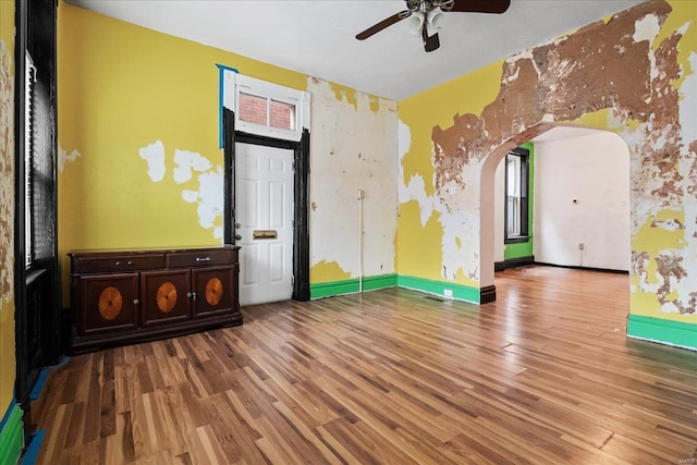 empty room with hardwood / wood-style floors and ceiling fan