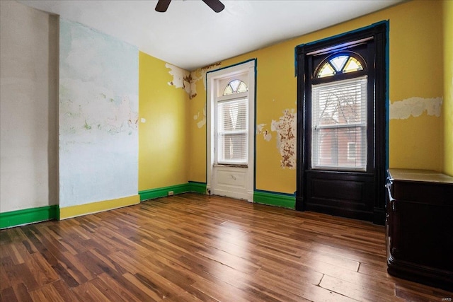 doorway featuring dark wood-type flooring and ceiling fan