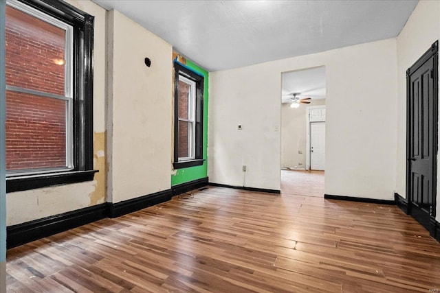 unfurnished room with wood-type flooring and ceiling fan