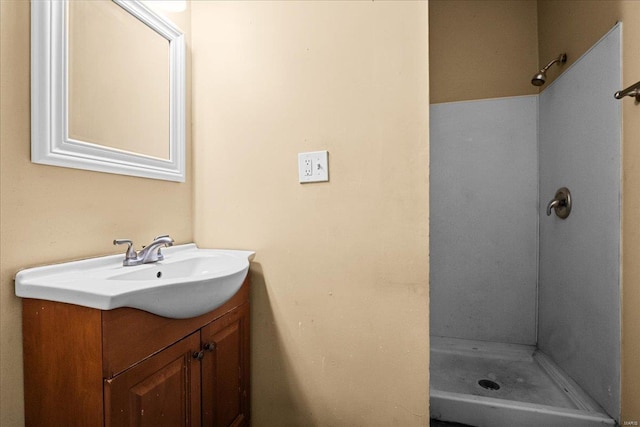 bathroom featuring walk in shower and vanity