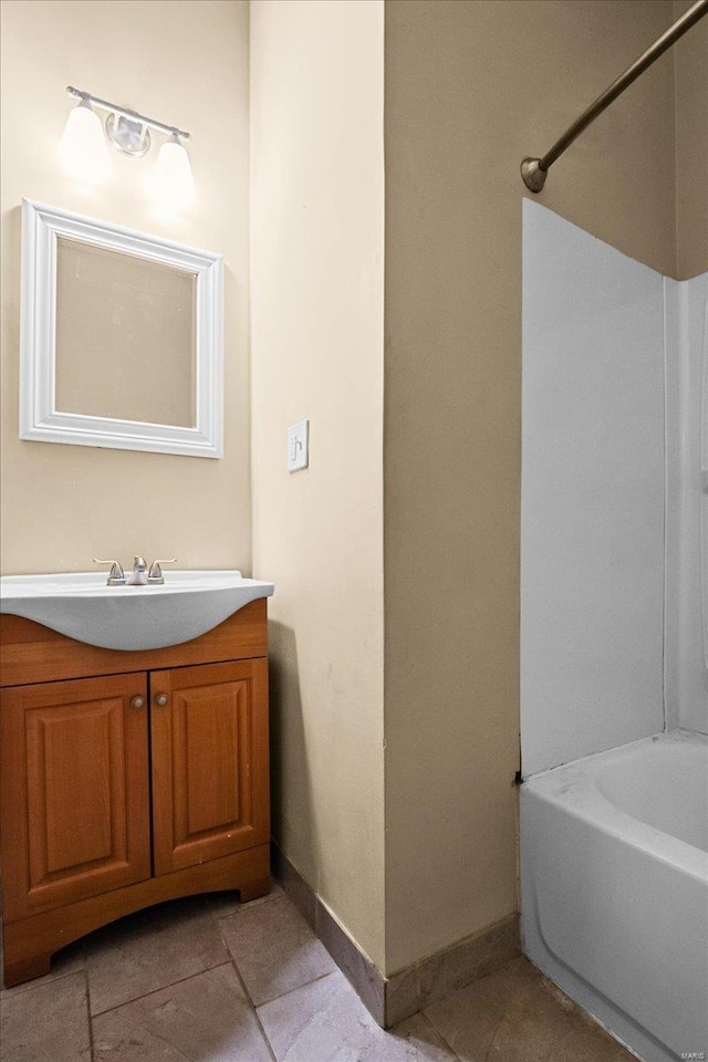 bathroom featuring vanity, tile patterned floors, and bathing tub / shower combination