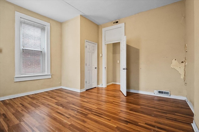 unfurnished room featuring hardwood / wood-style flooring