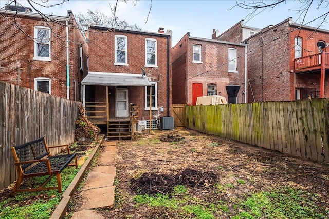 back of house with central AC unit