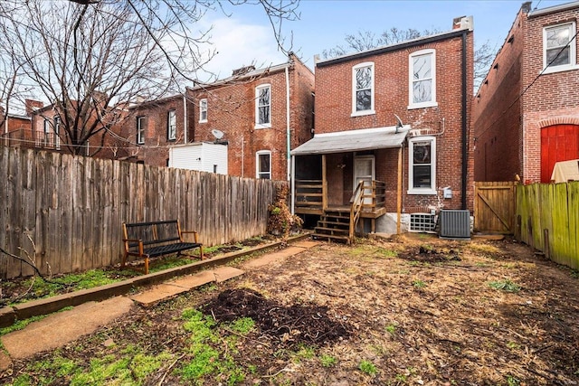 rear view of property with central AC