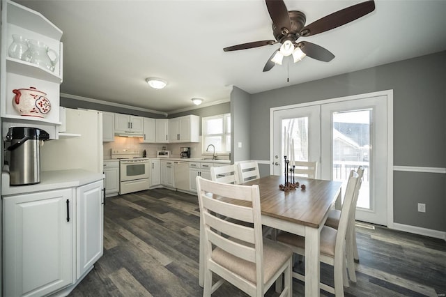 dining space featuring dark hardwood / wood-style flooring, sink, crown molding, and french doors