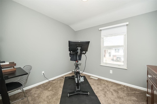 exercise area with vaulted ceiling and carpet flooring