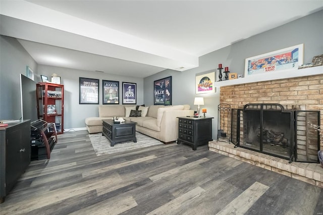 living room with a brick fireplace and hardwood / wood-style floors