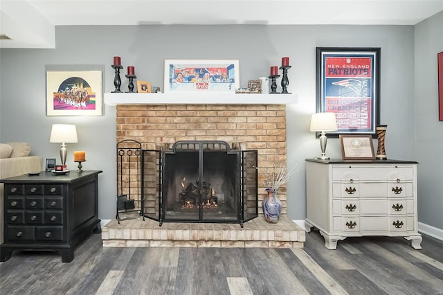 room details featuring hardwood / wood-style floors and a brick fireplace