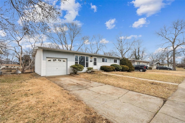 single story home with a garage and a front lawn