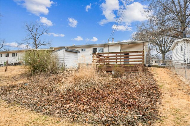 rear view of house with a wooden deck