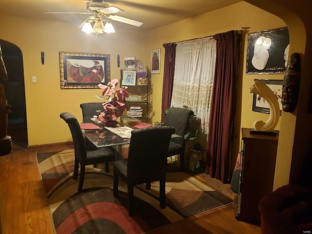 dining room with wood-type flooring and ceiling fan