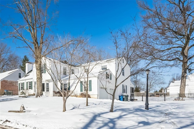 view of front of house with entry steps, fence, and a residential view