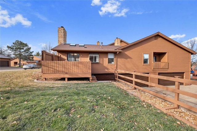 back of house with a wooden deck and a yard