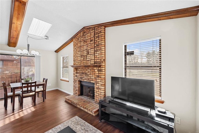 living room with lofted ceiling, a fireplace, dark hardwood / wood-style flooring, and an inviting chandelier