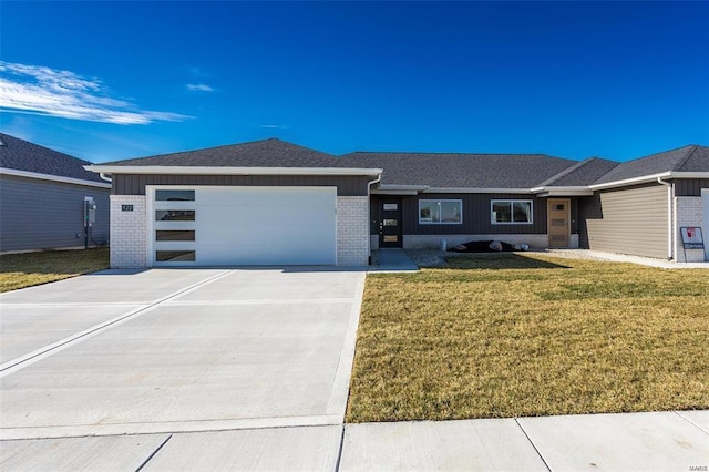 view of front of house featuring a garage and a front lawn