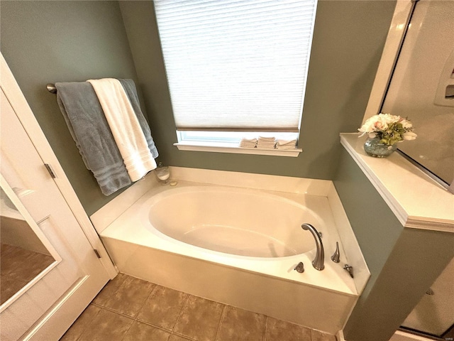 bathroom with tile patterned flooring and a bathing tub