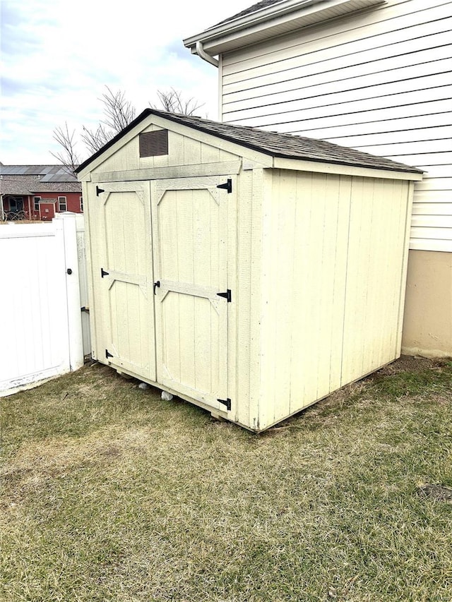 view of outbuilding with a lawn