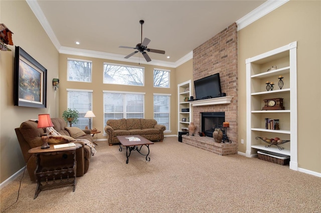 carpeted living room featuring crown molding, ceiling fan, a fireplace, and built in shelves