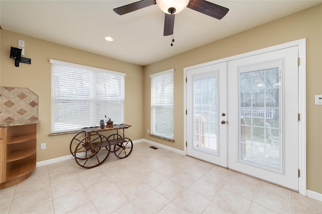 doorway with french doors, ceiling fan, and light tile patterned floors