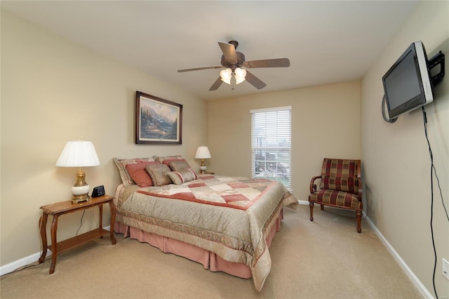 bedroom with ceiling fan and light colored carpet