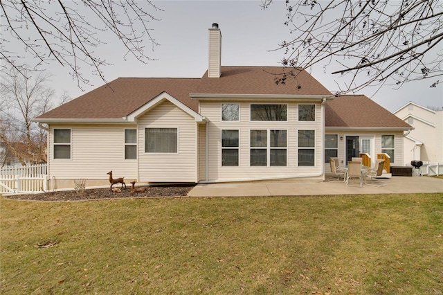 rear view of house with a lawn and a patio area