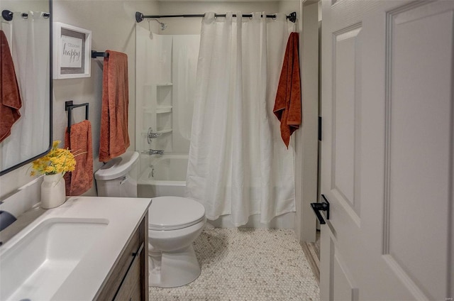 full bathroom featuring vanity, shower / bath combination with curtain, and toilet