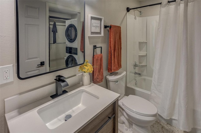 full bathroom with stacked washer / dryer, toilet, shower / tub combo, and vanity