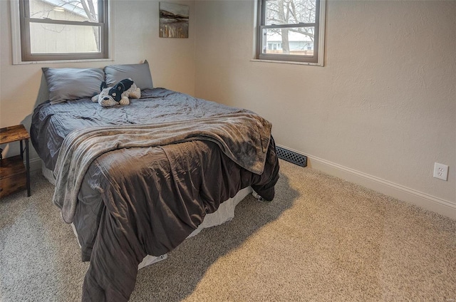 bedroom featuring light colored carpet