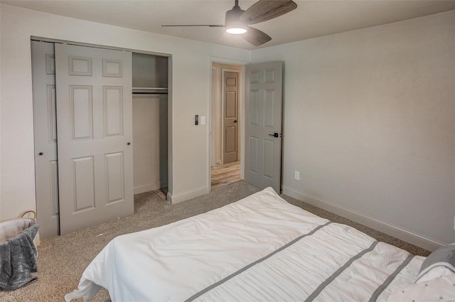 carpeted bedroom featuring ceiling fan and a closet