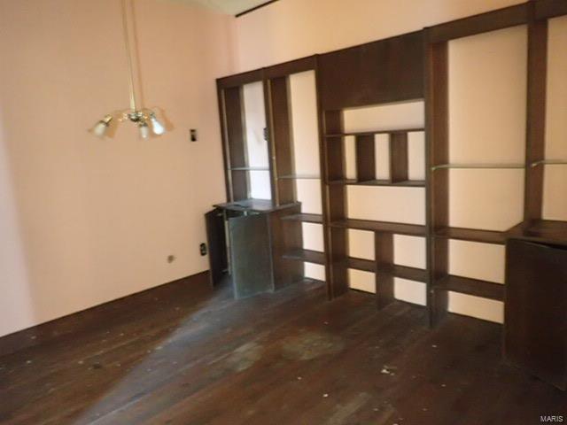 unfurnished room featuring dark wood-type flooring