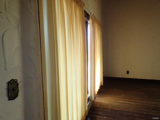 corridor featuring dark hardwood / wood-style flooring