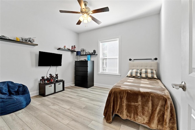 bedroom with light hardwood / wood-style flooring and ceiling fan