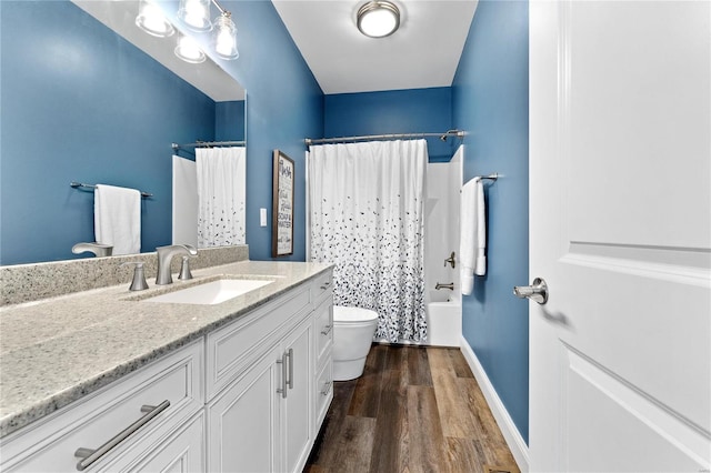 full bathroom with toilet, vanity, shower / bathtub combination with curtain, and hardwood / wood-style floors