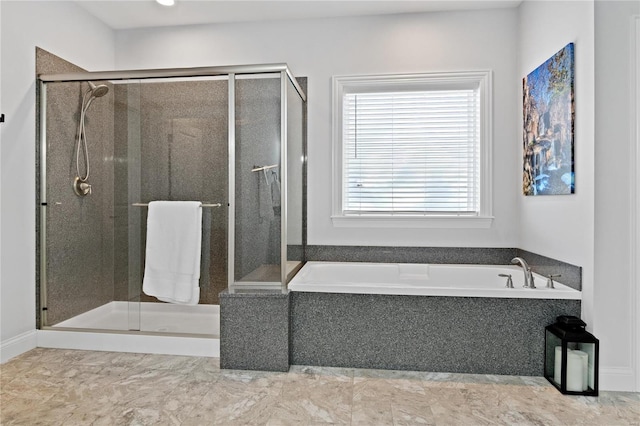 bathroom featuring shower with separate bathtub