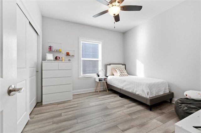 bedroom with ceiling fan, a closet, and light wood-type flooring