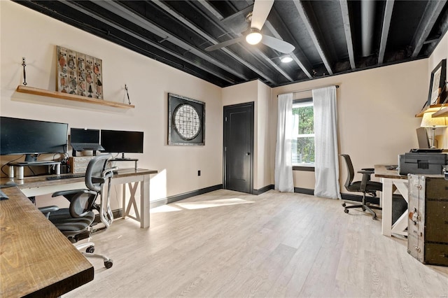 office space with beamed ceiling, ceiling fan, and light wood-type flooring