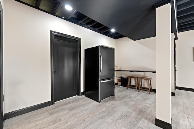 interior space featuring stainless steel fridge and light wood-type flooring