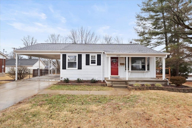 view of front of house featuring a front yard, a carport, and covered porch