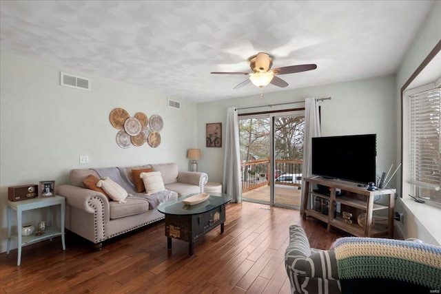 living room featuring dark hardwood / wood-style flooring and ceiling fan