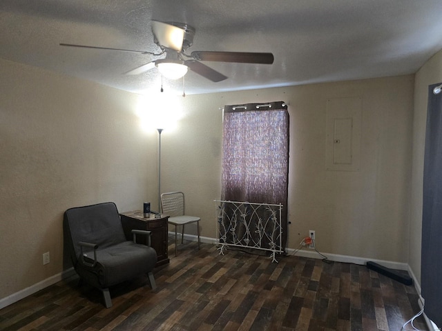 sitting room with dark hardwood / wood-style flooring, electric panel, and ceiling fan